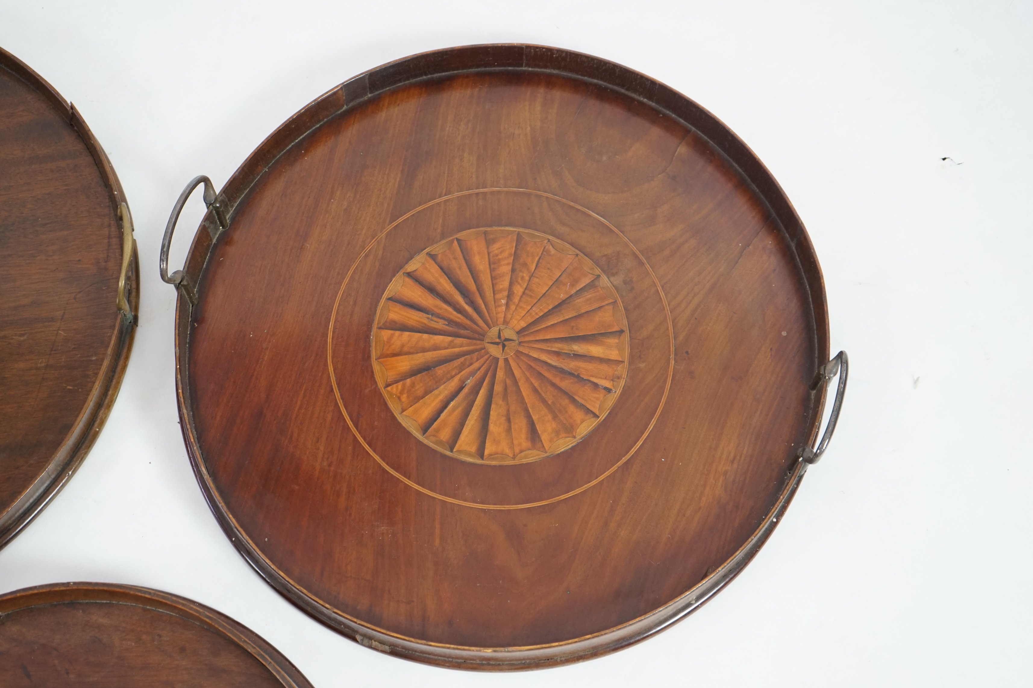 Three George III and later circular mahogany gallery trays